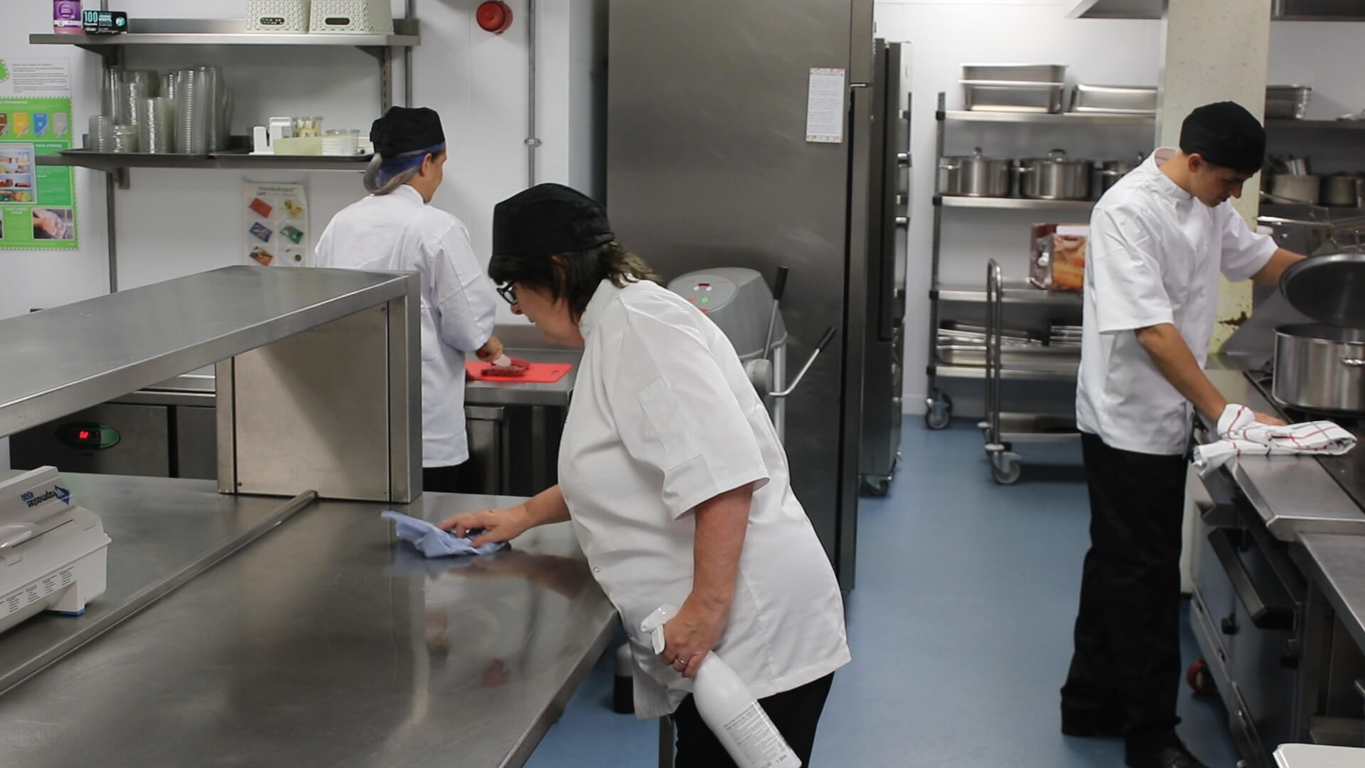 Staff in a kitchen putting into practice what they learned in their level 2 Food Safety and Hygiene course
